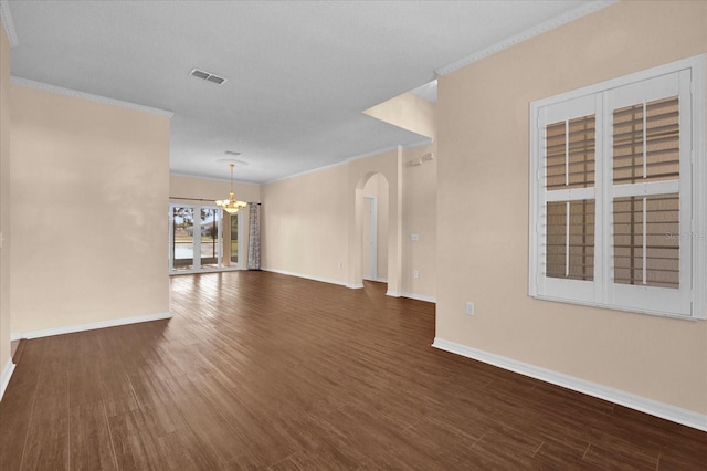 unfurnished living room featuring crown molding, a notable chandelier, a textured ceiling, and dark hardwood / wood-style flooring