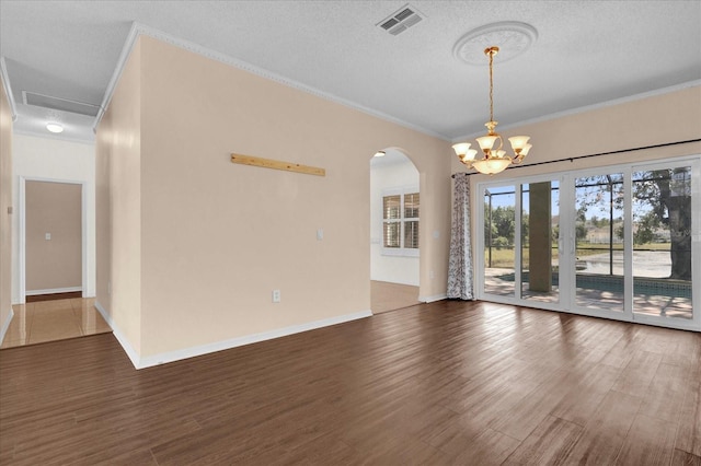 spare room with ornamental molding, a textured ceiling, and dark hardwood / wood-style floors