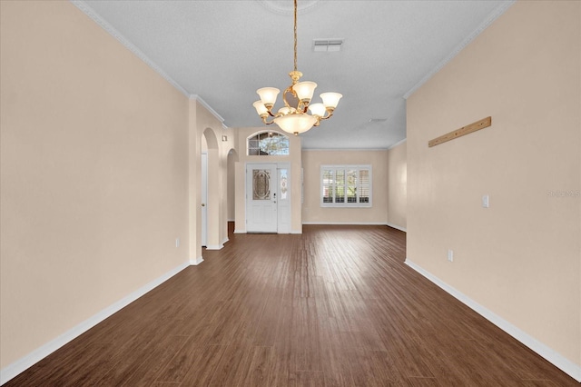 unfurnished living room featuring ornamental molding, a chandelier, a textured ceiling, and dark hardwood / wood-style flooring