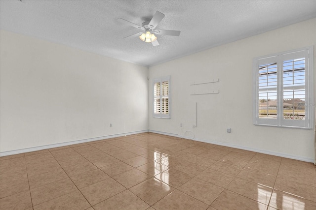 tiled spare room featuring ceiling fan and a textured ceiling