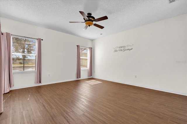 unfurnished room with a textured ceiling, hardwood / wood-style flooring, and ceiling fan