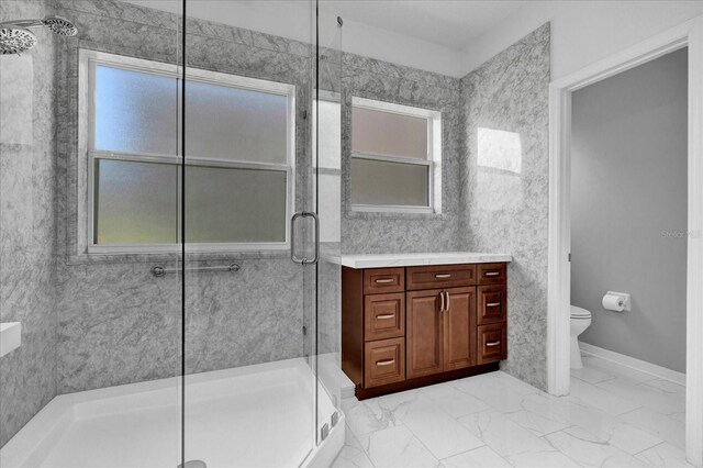 bathroom with vanity, a shower with shower door, and toilet