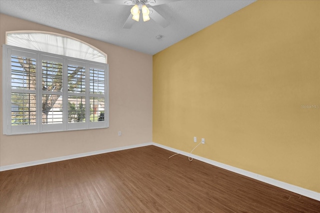 empty room with a textured ceiling, wood-type flooring, and ceiling fan