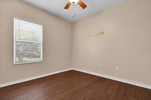 empty room featuring a textured ceiling, ceiling fan, and dark hardwood / wood-style flooring