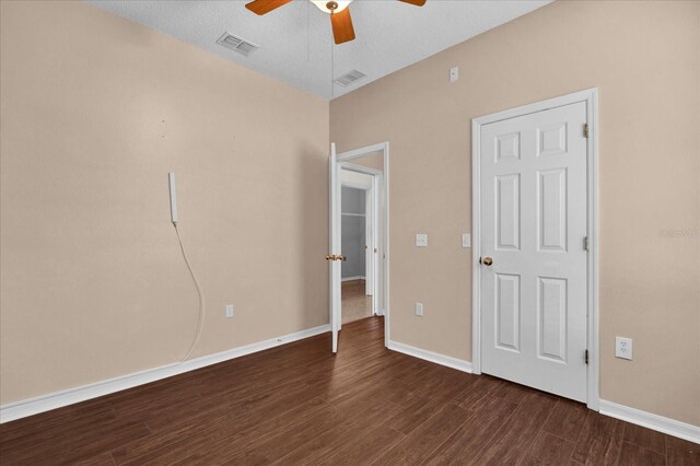 unfurnished bedroom featuring a textured ceiling, ceiling fan, and dark hardwood / wood-style floors