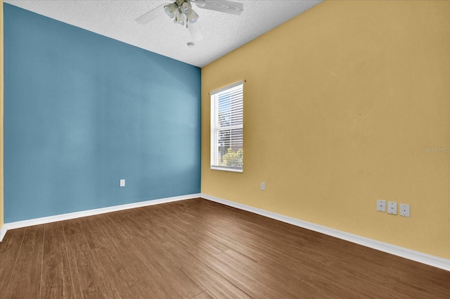 empty room with ceiling fan, a textured ceiling, and hardwood / wood-style floors