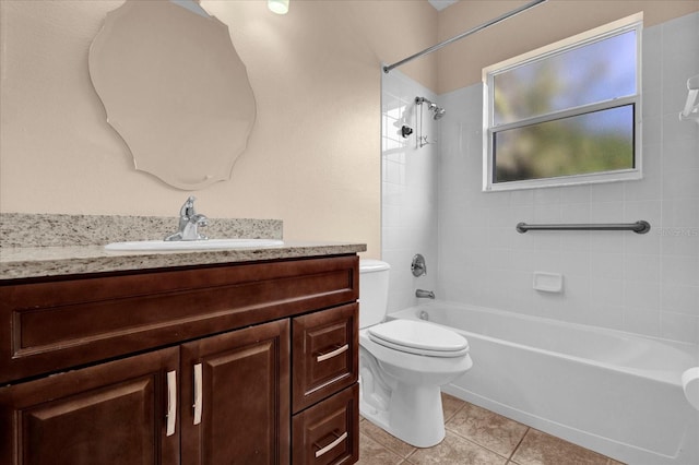 full bathroom featuring vanity, toilet, tiled shower / bath combo, and tile patterned flooring