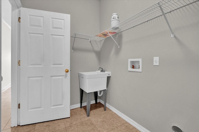 laundry room featuring light tile patterned flooring and hookup for a washing machine