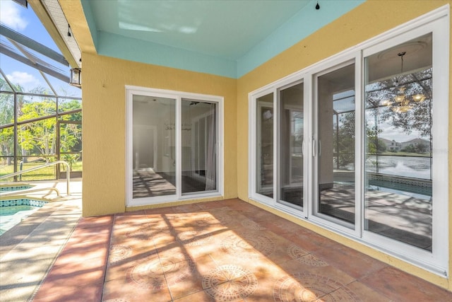 view of patio / terrace featuring glass enclosure