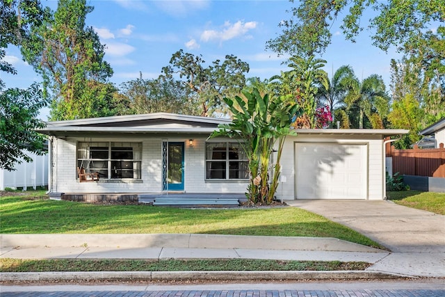 view of front of home featuring a front yard, a porch, and a garage