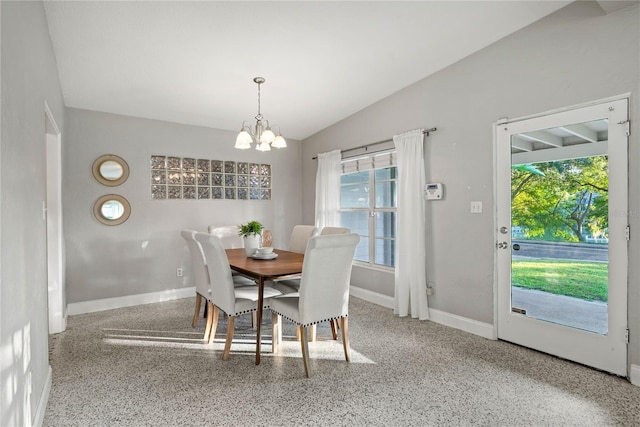 dining area with vaulted ceiling and a notable chandelier