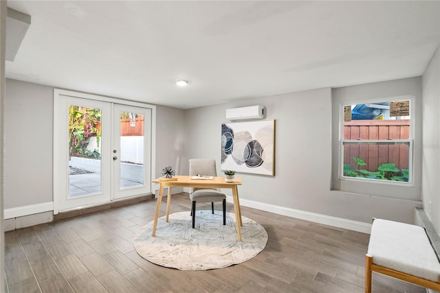 office with french doors, a wall mounted AC, and wood-type flooring