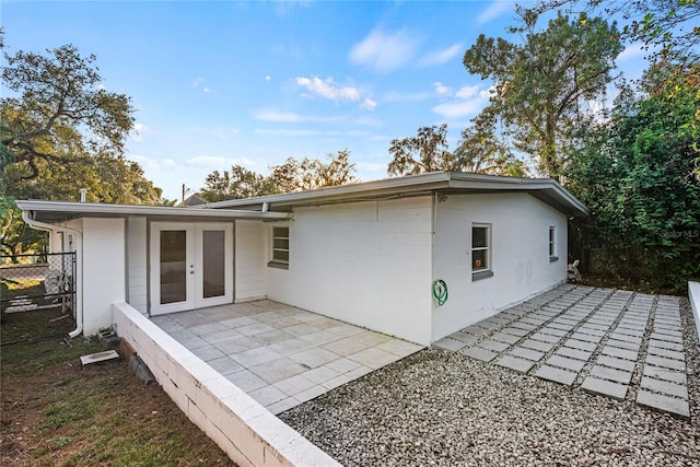 rear view of house featuring a patio area and french doors