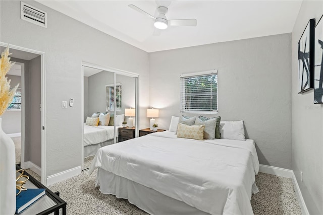 carpeted bedroom featuring a closet and ceiling fan