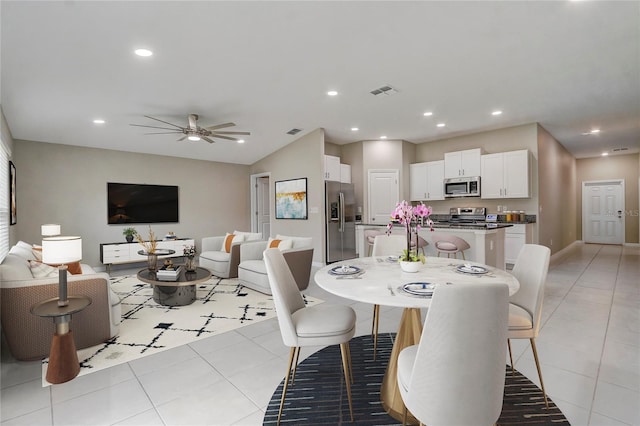 dining area featuring ceiling fan and light tile patterned floors