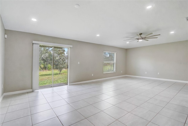 tiled empty room featuring ceiling fan