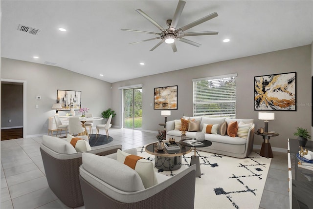 living room with ceiling fan, light tile patterned flooring, and vaulted ceiling