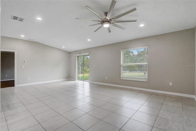 tiled empty room with lofted ceiling and ceiling fan