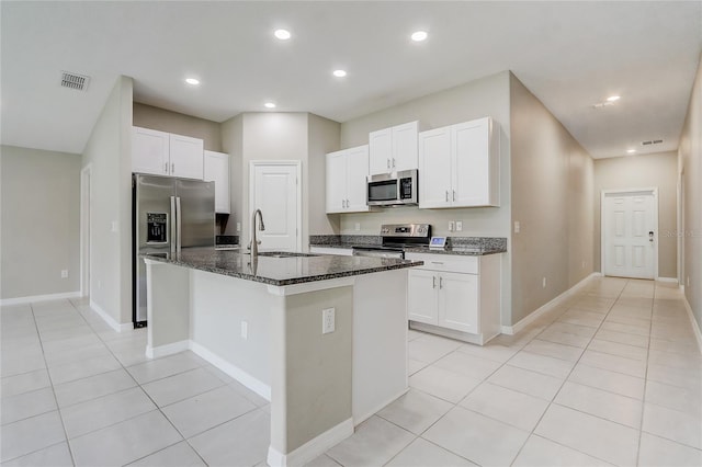 kitchen featuring white cabinetry, appliances with stainless steel finishes, sink, and a center island with sink