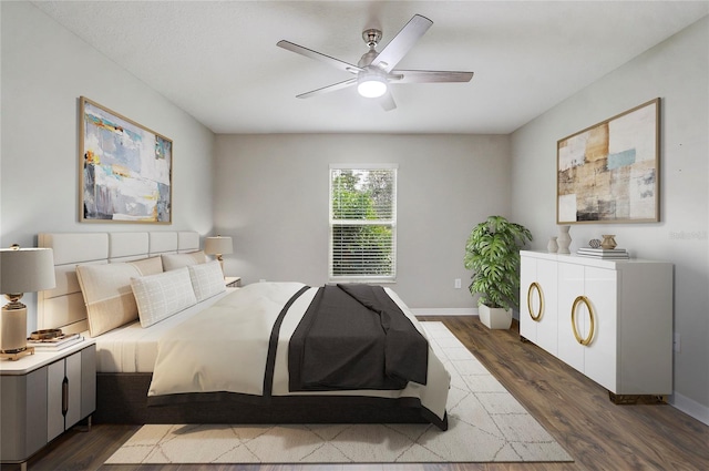 bedroom with ceiling fan and dark hardwood / wood-style flooring