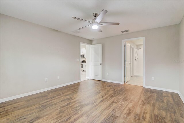 spare room featuring light hardwood / wood-style floors and ceiling fan