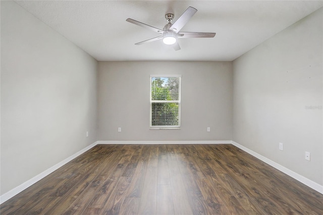 spare room with dark hardwood / wood-style floors and ceiling fan