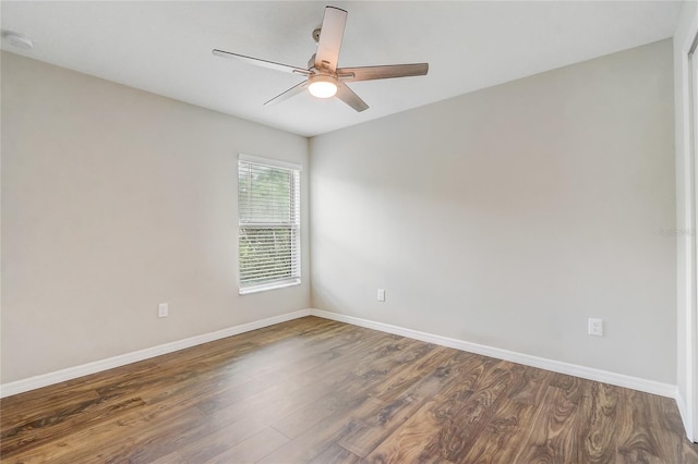 unfurnished room with ceiling fan and dark hardwood / wood-style flooring