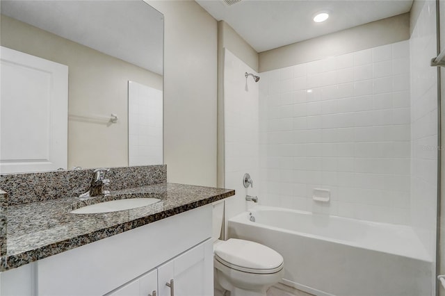 full bathroom featuring vanity, toilet, and tiled shower / bath combo