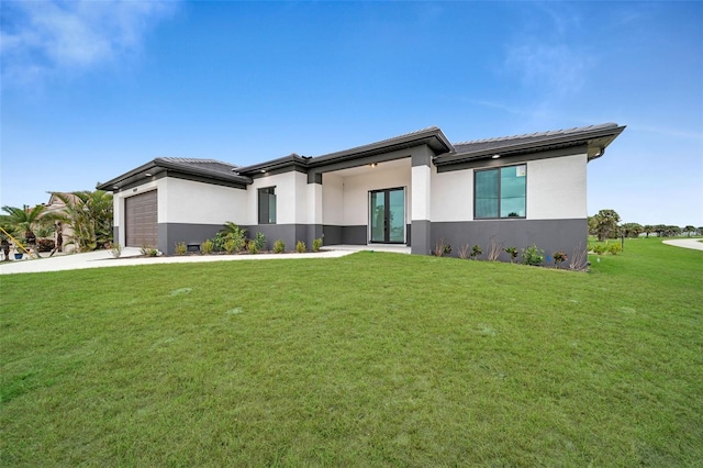 view of front of property with a garage and a front yard