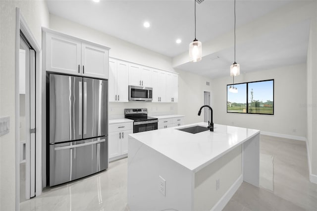 kitchen with stainless steel appliances, white cabinetry, sink, and decorative light fixtures