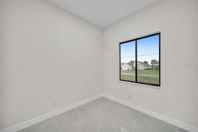 unfurnished room featuring light tile patterned flooring