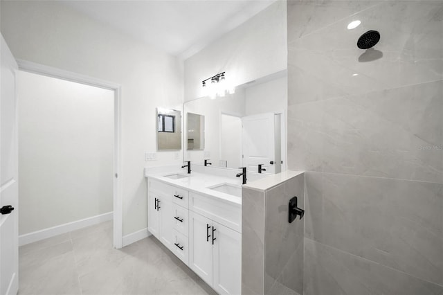 bathroom featuring vanity and tiled shower