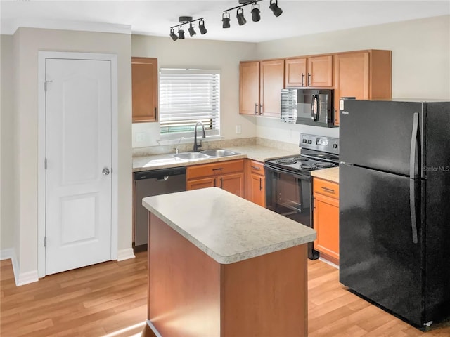 kitchen with a kitchen island, sink, black appliances, and light hardwood / wood-style floors