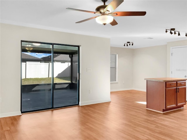 unfurnished room featuring light hardwood / wood-style floors and ceiling fan