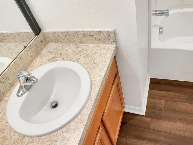 bathroom with vanity and hardwood / wood-style floors