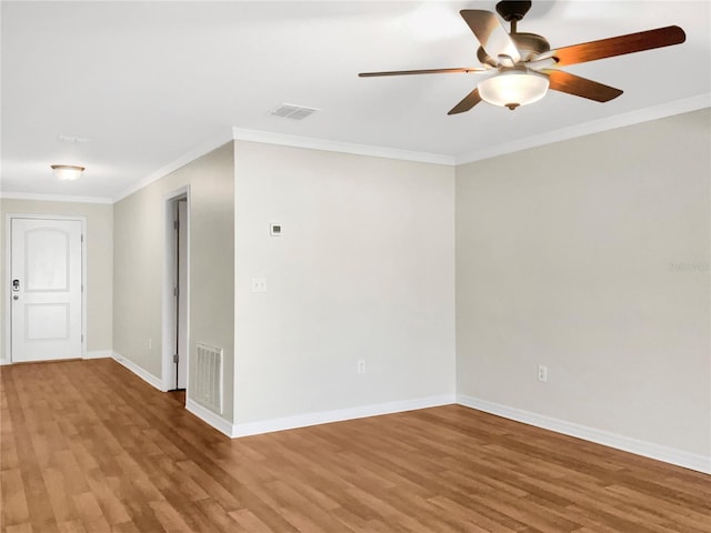 empty room featuring ornamental molding, hardwood / wood-style flooring, and ceiling fan