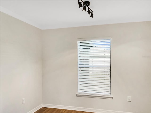 spare room featuring wood-type flooring