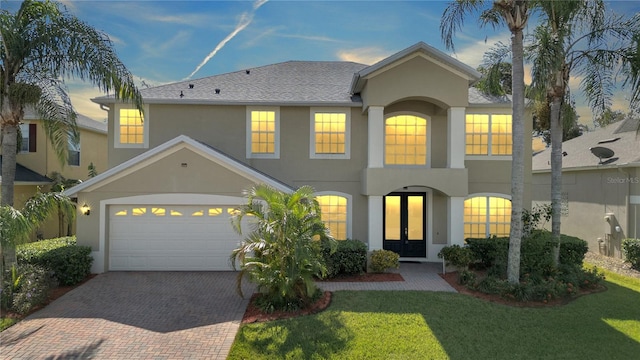 view of front of home featuring french doors and a yard