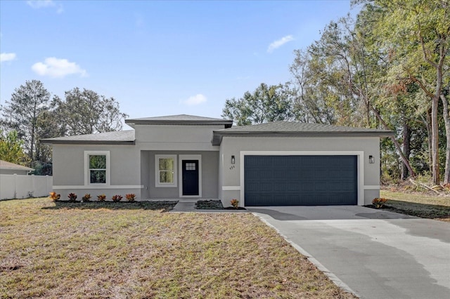 view of front of property featuring a front lawn and a garage