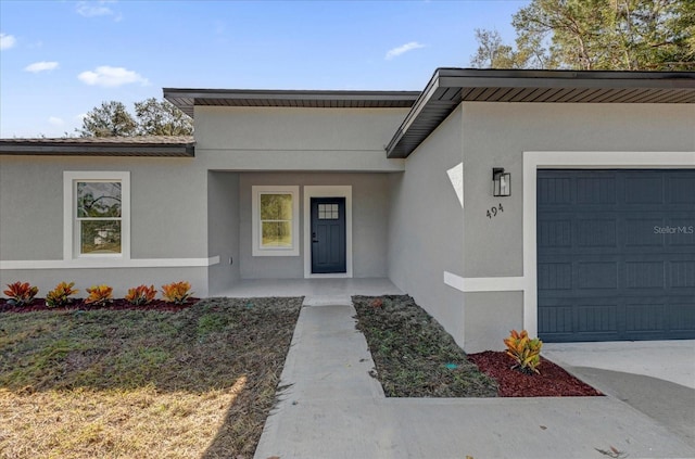 doorway to property with a garage