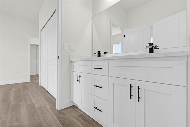 bathroom featuring vanity and hardwood / wood-style flooring