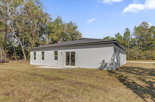 rear view of property with a patio area and a lawn