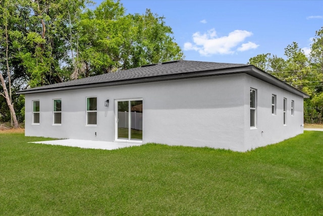 494 Marion Oaks Trl, Ocala, FL 34473 - back of property with stucco siding, a lawn, a shingled roof, and a patio