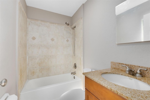 bathroom with toilet, vanity, and tub / shower combination