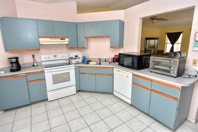 kitchen featuring ceiling fan, vaulted ceiling, sink, blue cabinets, and white appliances