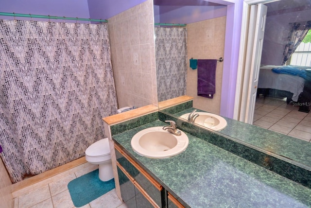 bathroom featuring vanity, toilet, a shower with curtain, and tile patterned flooring