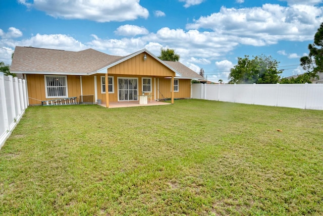 rear view of property with a yard