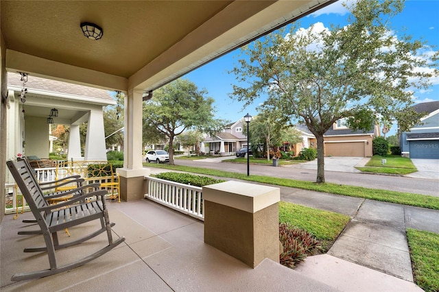 view of patio with covered porch and a garage