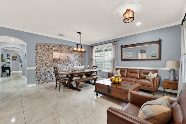 living room featuring a notable chandelier and ornamental molding