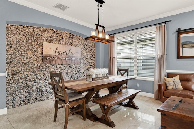 tiled dining room with crown molding, a barn door, and a chandelier